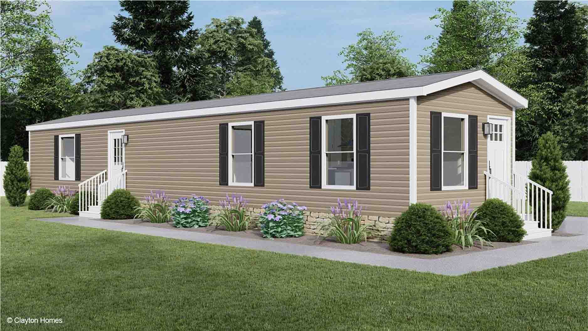 A beige single-wide manufactured home rendering with white trim, black shutters, and a small garden in front.