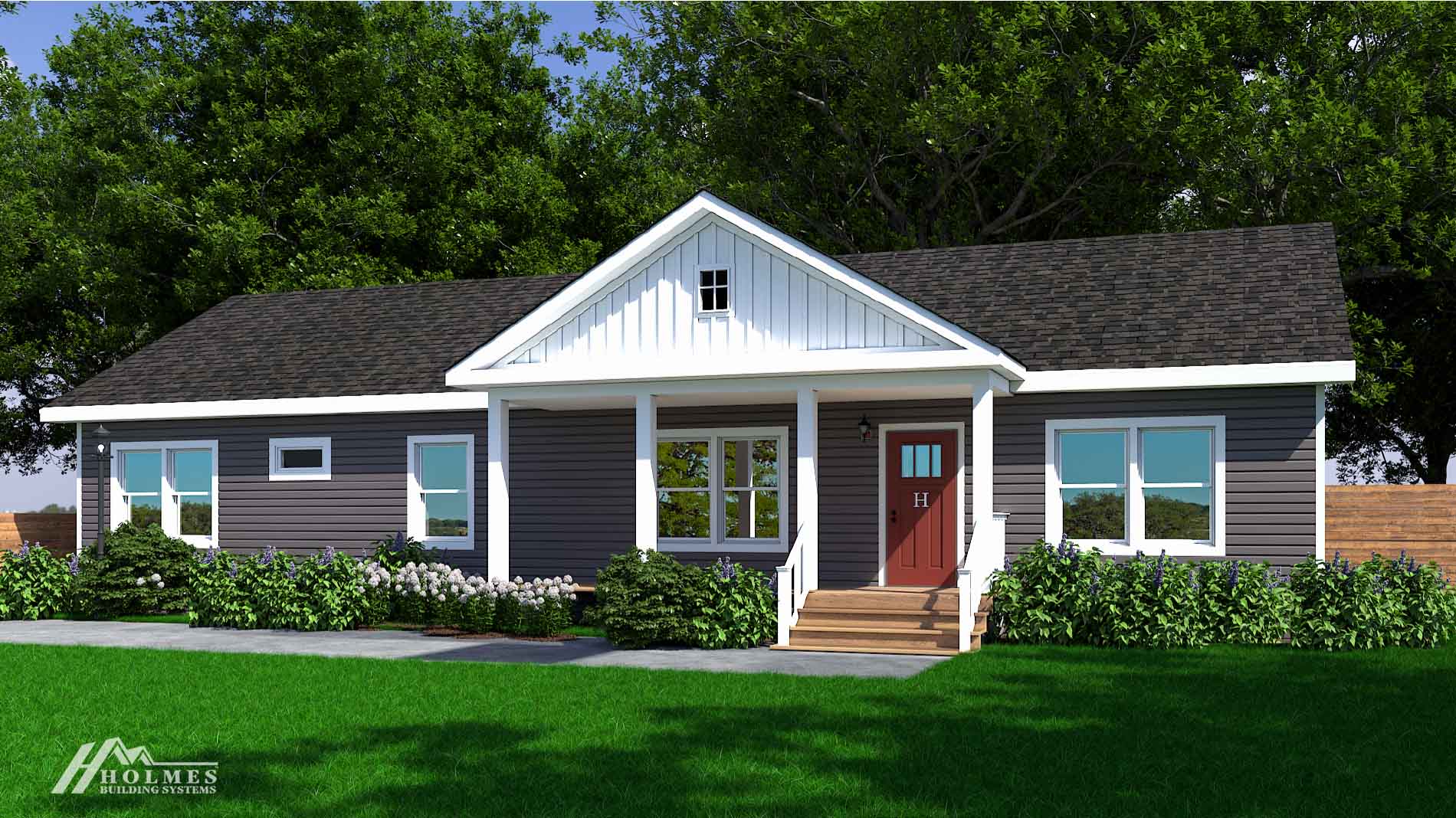 Single-story gray modular home with white trim, a front porch, red door, and green lawn accented with shrubs and trees.